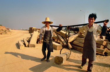 Workers at a lumber yard in the dusty suburbs of Shenzhen.