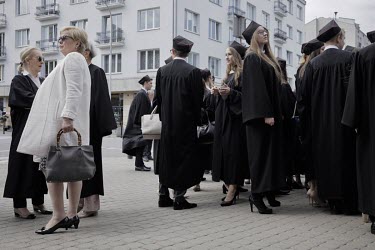 The head of the Supreme Court Malgorzata Gersdorf (left, in white), prepares to give a speech at the graduation ceremony of Warsaw University's Law Faculty in which she reminded students of European v...
