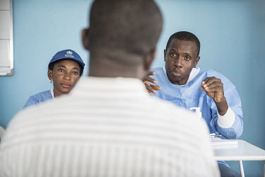 Guinean doctors, who gained much experience during the 2014 outbreak, talk with a Congolese health worker about the new, and still experimental, Ebola vaccine which is being made available to medical...