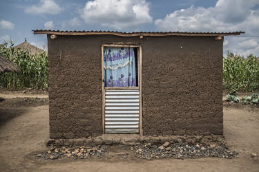 A traditional mud-built hut belonging to Malis Justin, a South Sudanese refugee, stands on his plot of land in Bidibidi refugee camp. This building is where his children sleep.