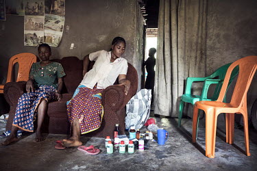 Mboyo Mola, a widow whose husband died from Ebola, sits at home beside the medicines left after her husband died. According to Mboyo, her husband was poisoned and did not die from Ebola.