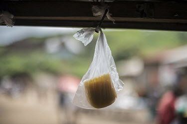 Wedges of Masisi gouda, hang in plastic bags from a peg in a cafe in the village of Katale where they are for sale.