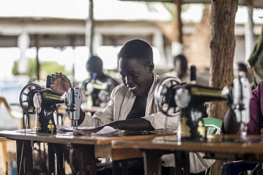 Joanne Mary, a young single mother living in Bidibidi refugee camp, takes part in a tailoring class, learning, among other things, how to make reusable sanitary pads to sell.