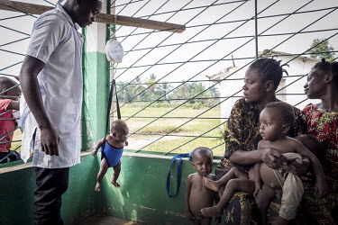 A child is weighed at a rural health post.