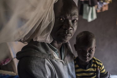 Malis Joseph, a refugee from South Sudan, with his two year old daughter, Flora, in Bidibidi refugee camp. He supports three wives, 21 of his own children and five unaccompanied nephews and nieces orp...