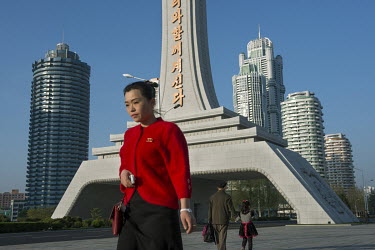 A woman stands near a huge triumphal arch emblazoned with the words: 'The great leaders Kim Il Sung and Kim Jong Il will always be with us', on New Ryomyong street which was inaugurated in April 2017.