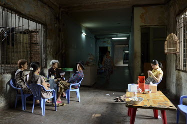 A group of women gather in a small cafe-restaurant nicknamed Bun Bo Hue on the 1st floor of the former Le President Hotel which was used by the American military in the 1960s up until the evacuation o...