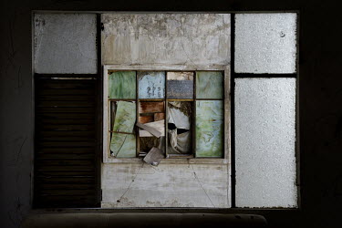 A boarded up window in the former Le President Hotel which was used by the American military in the 1960s up until the evacuation of 1975. Many of the rooms in the dilapidated building were let cheapl...