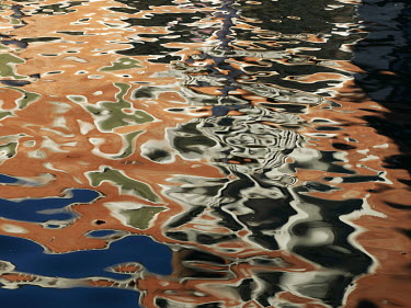 Ripples and reflections of buildings on a canal in sestiere (district) San Polo.