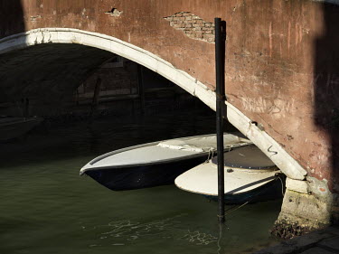 Gondolas moored beneath a bridge Castello.