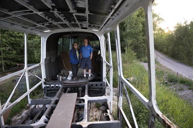 Tom Laukka and Pia Akerlund stand in the shell of an old bus which they hope to convert into a camper van outside their house near Storvik. 'I started working as a driver when I was 20. Truck, taxi, a...