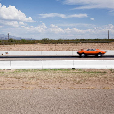 A car races the one mile strip at the Tucson Dragway where vehicles originally manufactured between the 1950s and 1980s, and now owned mainly by well off pensioners, compete against each other.