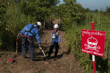 Srey Yen in the Chomka Chek minefield overseeing a member of her team a they work demining part of the K-5 barrier minefield on the Thai-Cambodian border.