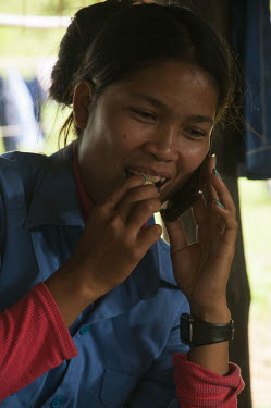 Srey Yen speaks with her father during a break back at the HALO camp near the Chomka Chek minefield on the Thai-Cambodian border.