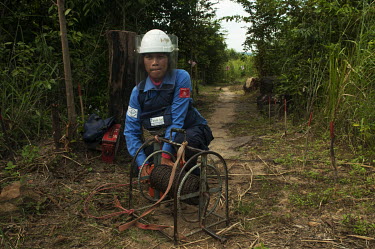 Srey Yen prepares a Hungarian GYATA anti-personnel landmine for destruction in the Chomka Chek minefield on the Thai-Cambodian border.