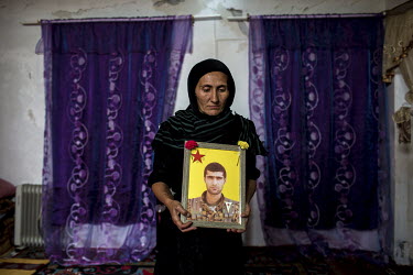 Iranian refugee, Afsana, holds a picture of her son who was killed by so-called Islamic State (Daesh) in Syria.