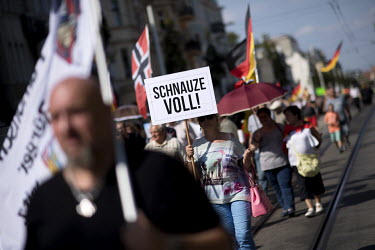 A woman carries a placard during a rally of the right-wing organisation Zukunft Heimat (Homeland Future) who gathered to protest against 'the high number of mostly Muslim refugees who have moved to Co...