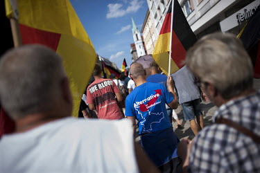 People carry flags during a rally of the right-wing organisation Zukunft Heimat (Homeland Future) who gathered to protest against 'the high number of mostly Muslim refugees who have moved to Cottbus o...