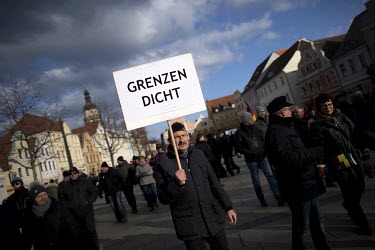 A man holds a placard that reads: 'Close the borders' ('Grenzen Dicht') during a rally of the right-wing organisation Zukunft Heimat (Homeland Future) who gathered to protest against 'the high number...