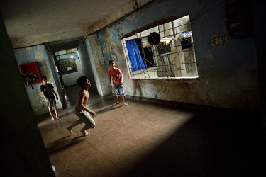 Youths play football in a corridor at the former Le President Hotel on Tran Hung Dao Street. It was used by the American military during the 1960s up until the evacuation of 1975. Many of the rooms in...