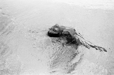 A woman swimming in a thermal spring.
