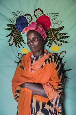 Esther Minella in front of her Milaya (a traditional hand-decorated sheet) in the Bidibidi refugee settlement. She was working in the ministry of agriculture in South Sudan before the war broke out. O...