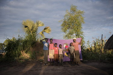 Joyce Sadia (44) with her children Khemis, Flora and Lona and her brother's sons James and Thomas in front of her Milaya (a traditional hand-decorated sheet) in the Bidibidi refugee settlement. Joyce,...