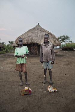 Wane Samuel and Cosmas Amule (10) with their home-made toy cars in the Bidibidi refugee settlement.