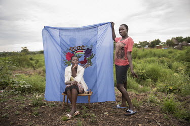 Rita Kwaje and Matoszi William, both 17 and from Yei in South Sudan with a Milaya (a traditional hand-decorated sheet) in the Bidibidi refugee settlement. The two young women didn't know each other be...