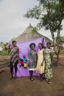 Emelda Benjamin (to the right), with her half-sisters Jaqueline, Margret and Rebecca, in front of her Milaya (a traditional hand-decorated sheet) in the Bidibidi refugee settlement. She takes care of...