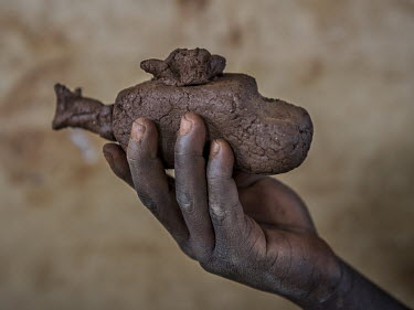 A toy helicopter made of clay by Maita Alafi (6) a refugee from South Sudan living in the Bidibidi refugee settlement.