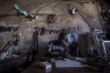 A jeweller makes a piece of wedding jewellery in his workshop in Domoni's old town. Weddings are such a big part of Comorian life and involve the giving of such large quantities of gold and silver, th...