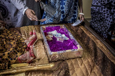 Wedding guests leave money in a box at the foot of the bride's bed on the morning of her marriage.