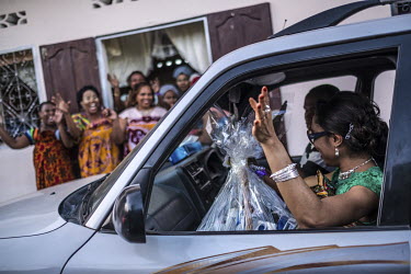 Members of the bride's family arrive with gifts at the home of the groom on the day of 'Massingo' during the two week's of events for a wedding.