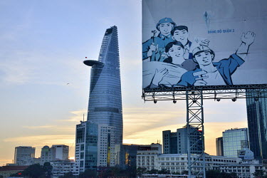 A propaganda poster in District 2 with modern architecture in the city centre.