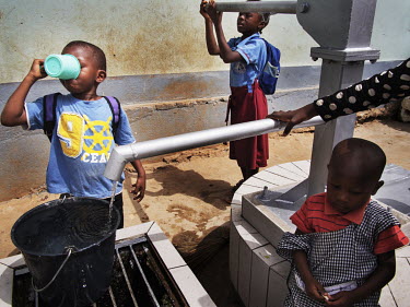 Pupils at the Notre Dame orphanage and school pumps water from the school's newly installed water pump.