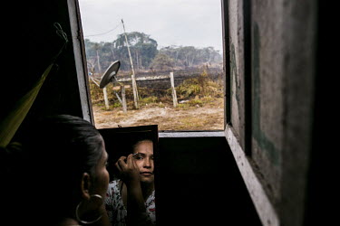 Former FARC guerrilla, Dayana applies some make-up before she returns to the transition camp in Colinas to collect the belongings she left there. Describing life in the jungle Dayana says: 'We used to...