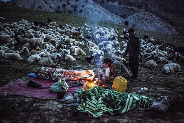 Bakhtiari nomads, the Muslim family, sleep beside a fire at a camp during the annual migration of people and livestock. They will break camp at sunrise and then camp again at nightfall a daily routine...
