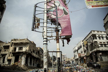 The remnants of an advertising billboard stands among the ruins of Taiz, a frontline city destroyed in the conflict.