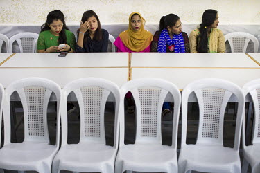 South Asian migrants who work in a garment factory near the capital where they are holding a meeting in the union committee room.