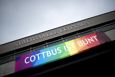 A banner hanging above the town hall's entrance reads: 'Cottbus is multicoloured' and refers to an anti-racism campaign involving the football club FC Energie Cottbus and the local authority.