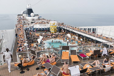 Sunbathing guests on the crowded deck of the MSC Musica, a cruise ship owned by the Mediterranean Shipping Company. The ship takes 2000 passengers on a cruise through the Persian Gulf and the Gulf of...