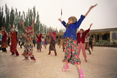 Uygur school children taking part in early morning exercises in their school's courtyard.