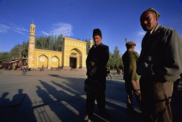 Uygur men stand in front of Kashgar's Id Kah Mosque.