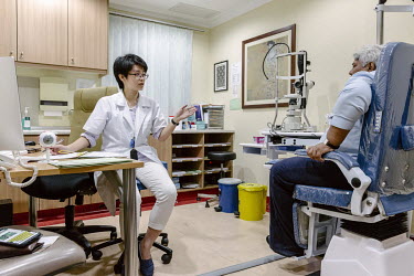 A doctor talks with a patient at the Tun Hussein Onn National Eye Hospital.