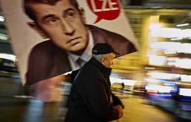 A man carries a placard with a photo of Andrej Babis with a speech bubble conatining one word: 'LÅ�E' (Lies) at a rally where thousands demanded the resignation of the Czech Prime Minister.