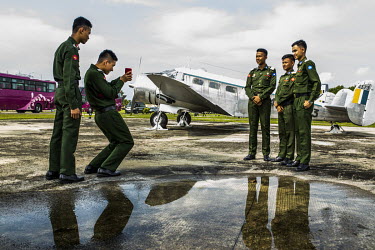 During a weekend excursion, young cadets from a military services academy take a picture in front military planes displayed inside the compound of the Defence Services Museum.