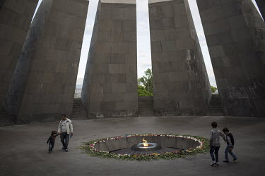 Visitors at the Tsitsernakaberd Memorial, dedicated to the 1915 Armenian Genocide, on a hill overlooking Yerevan. Made up of 12 basalt slabs leaning inward over an eternal flame, the memorial symboliz...