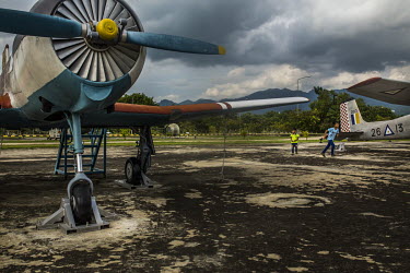 Two boys playing near old military planes on display in the compound of the Defence Services Museum.