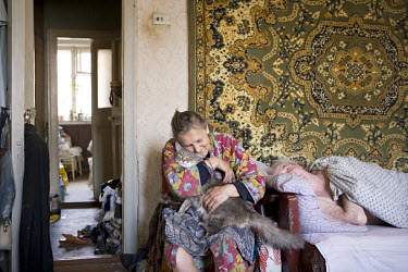 Aleksiyeva Praskovya Varanovska (72) hugging her pet cat where she lives together with her sick brother, in a small and dirty flat on Prospekt Lenina. She has to survive on a monthly pension worth abo...